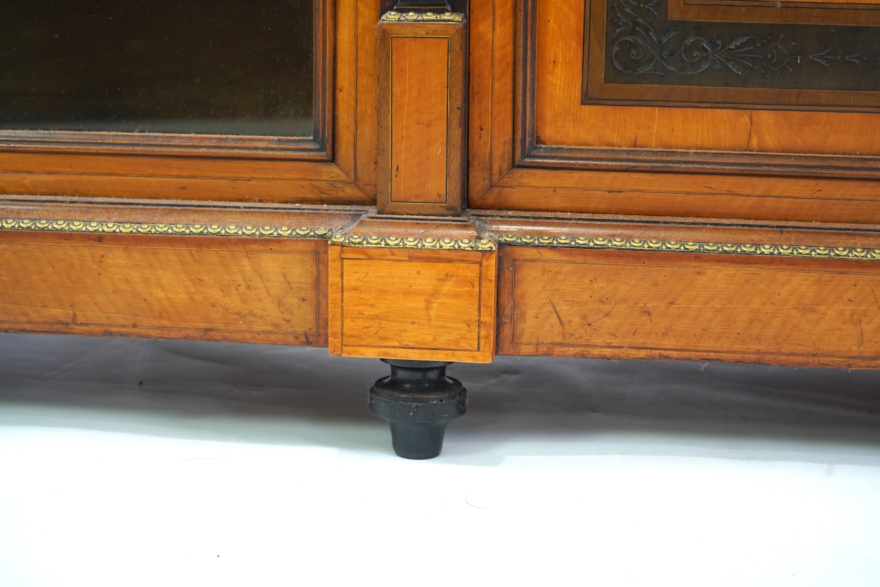A Victorian marquetry inlaid and gilt metal mounted banded satinwood side cabinet, with anthemion carved frieze over a central door applied octagonal Wedgwood style green and white octagonal jasper plaque, flanked by gla